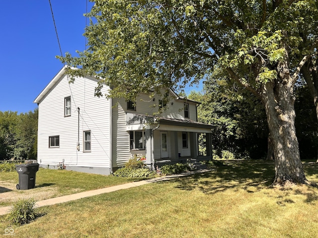 view of front facade with a front lawn and a porch