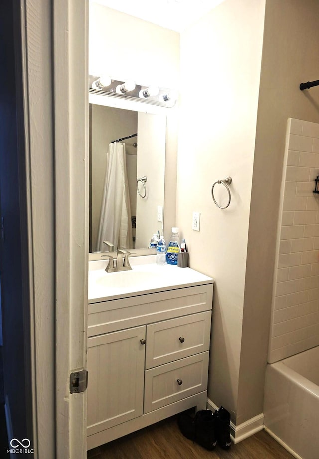 bathroom featuring vanity, shower / bath combination with curtain, and hardwood / wood-style flooring