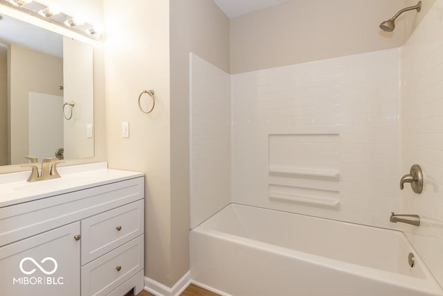 bathroom featuring vanity and  shower combination