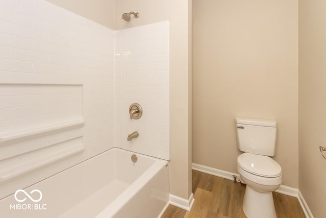 bathroom featuring shower / washtub combination, wood-type flooring, and toilet