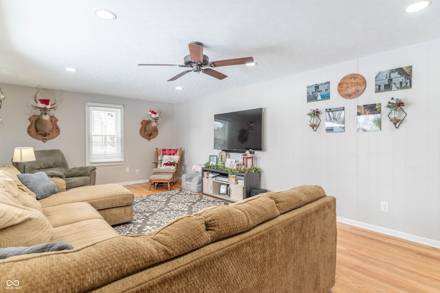 living room featuring ceiling fan and hardwood / wood-style floors