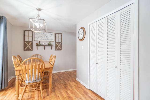 dining area featuring light hardwood / wood-style floors and a chandelier