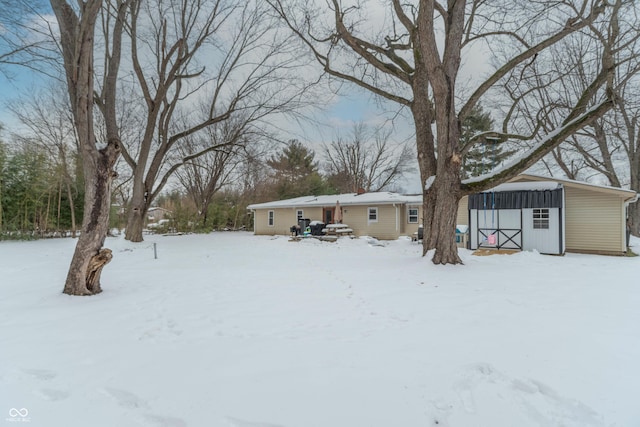 yard covered in snow with an outdoor structure