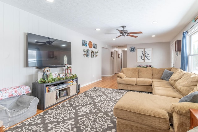 living room with light hardwood / wood-style flooring and a textured ceiling