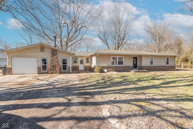 ranch-style house featuring a garage and a front yard