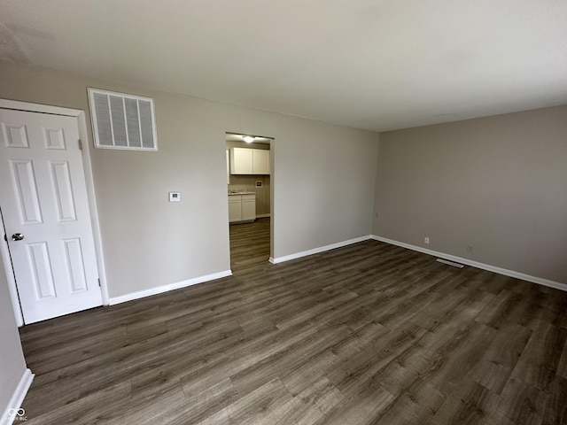 unfurnished bedroom featuring a closet and dark hardwood / wood-style floors