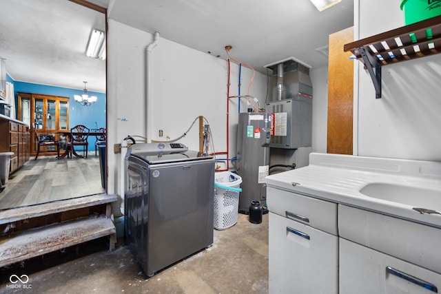 washroom featuring washer / clothes dryer, heating unit, a notable chandelier, and water heater