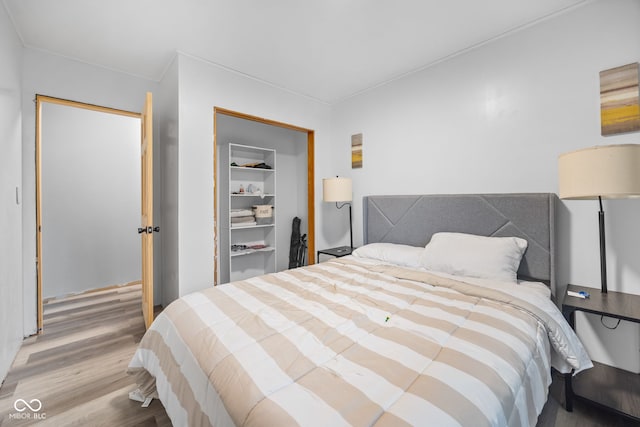 bedroom with hardwood / wood-style floors and a closet