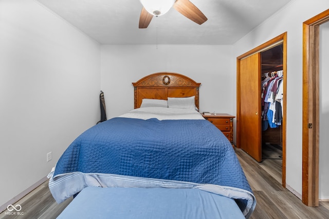 bedroom with hardwood / wood-style floors, a closet, and ceiling fan