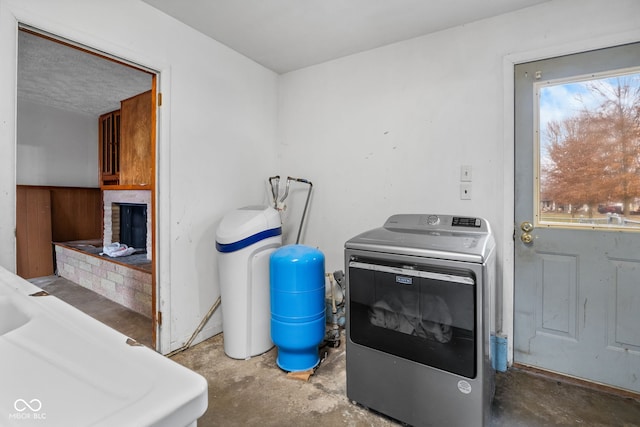 laundry area featuring washer / clothes dryer and a brick fireplace