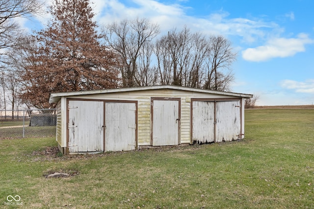 view of outbuilding featuring a lawn