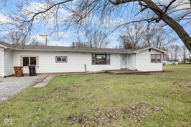 rear view of property featuring a patio area and a lawn