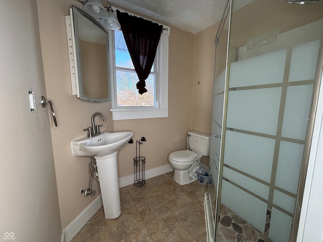 bathroom with a textured ceiling and toilet