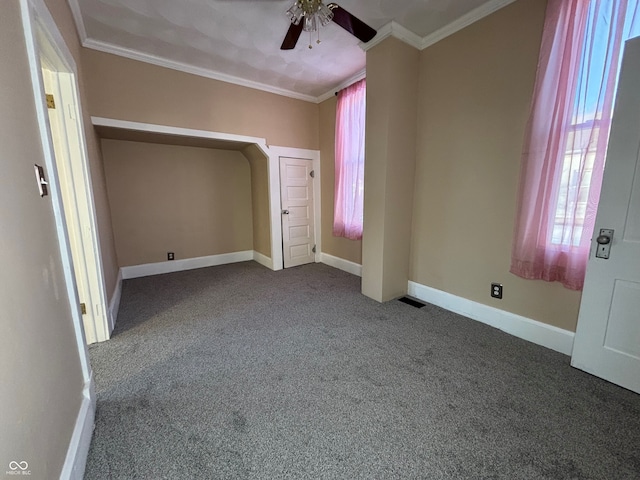 unfurnished bedroom with ceiling fan, crown molding, and carpet