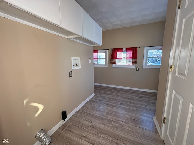 laundry room with cabinets, hookup for a washing machine, and hardwood / wood-style floors