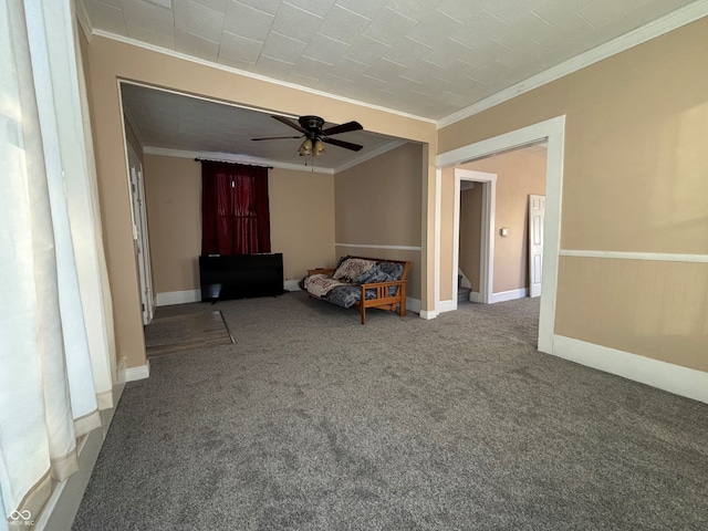 carpeted spare room with ceiling fan and crown molding