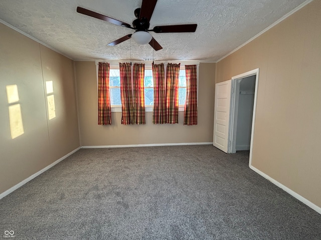 empty room featuring ceiling fan, crown molding, carpet, and a textured ceiling