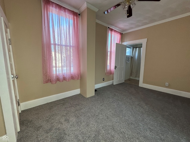 unfurnished bedroom with ceiling fan, crown molding, and carpet flooring