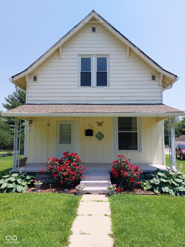 325 S Market St, Thorntown, IN 46071 - farmhouse-style home with a porch, a front lawn, and a shingled roof