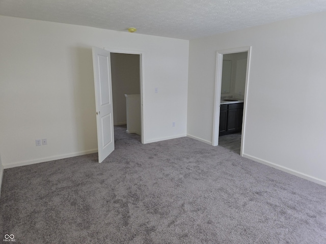 unfurnished room with carpet floors and a textured ceiling