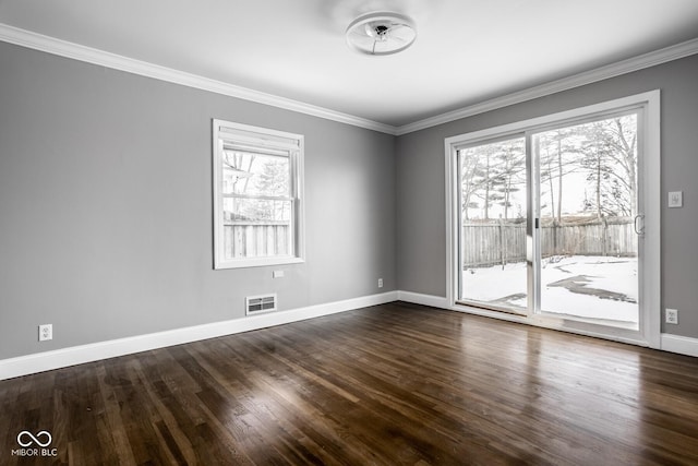 empty room with ornamental molding, plenty of natural light, and dark wood-type flooring