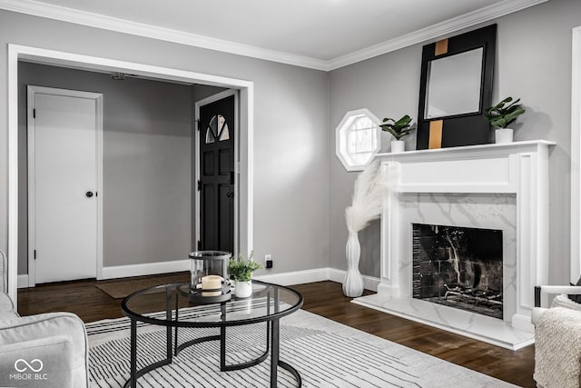 living room featuring hardwood / wood-style flooring, crown molding, and a premium fireplace