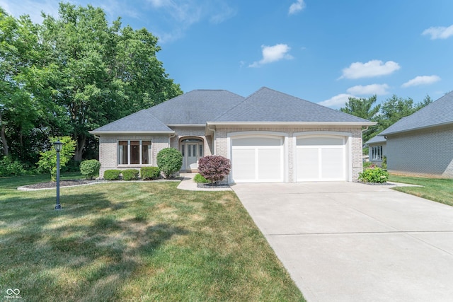 view of front facade with a front yard and a garage