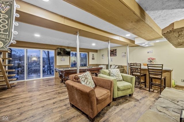 living room with hardwood / wood-style floors and pool table