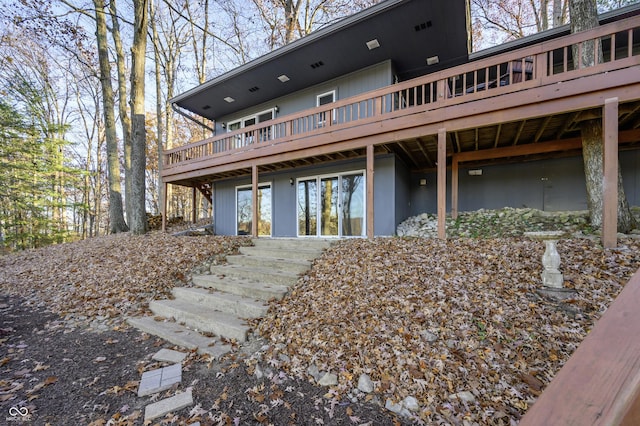 rear view of house with a wooden deck