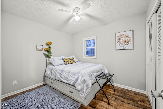 bedroom featuring a textured ceiling, a closet, ceiling fan, and dark hardwood / wood-style floors