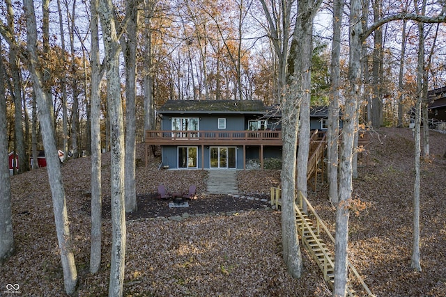 back of property with a wooden deck