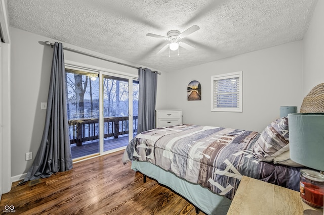 bedroom with access to outside, ceiling fan, dark hardwood / wood-style flooring, and a textured ceiling