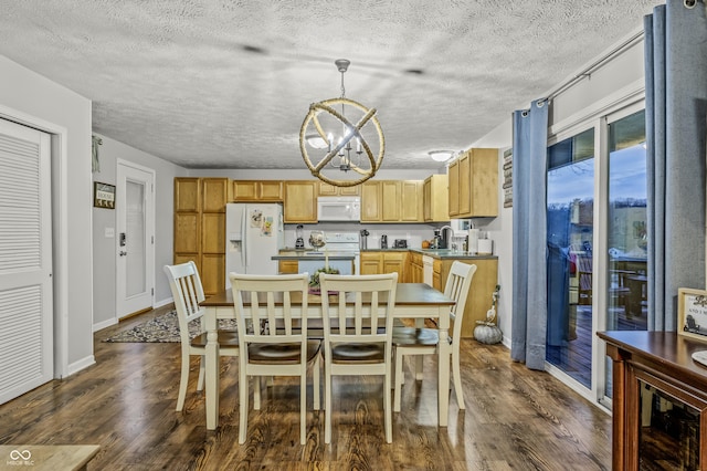 dining area featuring dark wood-type flooring, a notable chandelier, and sink