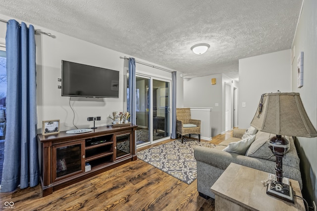 living room with hardwood / wood-style floors and a textured ceiling