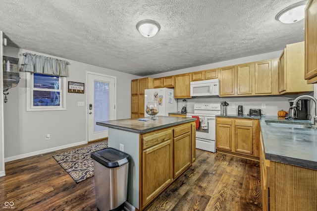 kitchen with a center island, white appliances, sink, and dark wood-type flooring