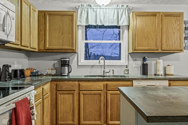 kitchen featuring white appliances and sink