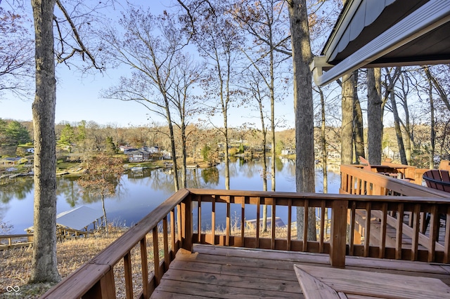 wooden terrace featuring a water view