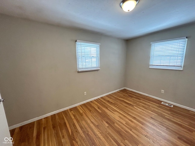 spare room with hardwood / wood-style floors