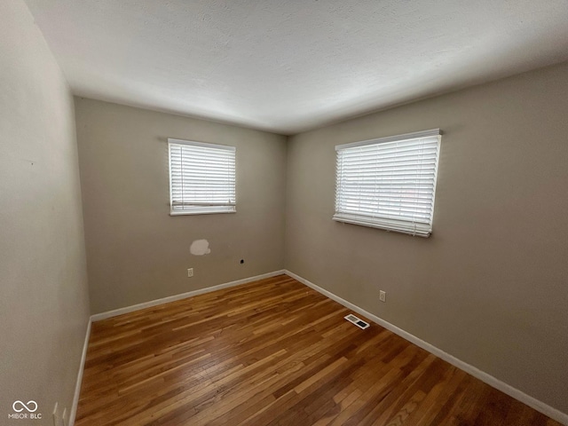 empty room featuring hardwood / wood-style flooring