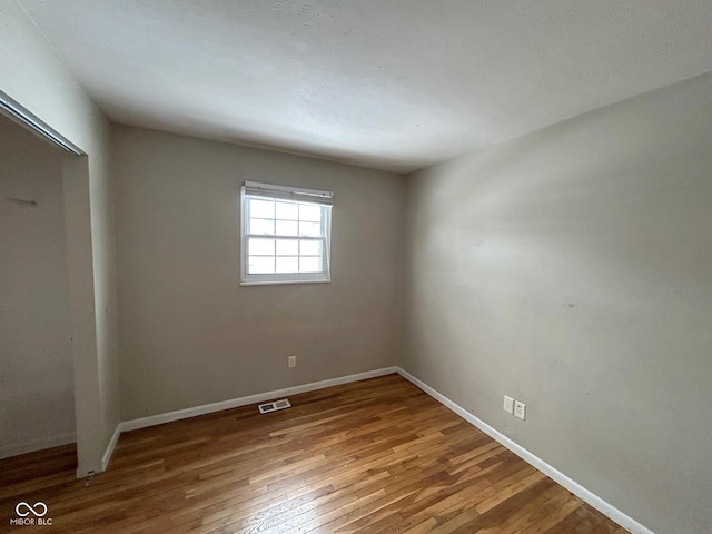 unfurnished bedroom with wood-type flooring