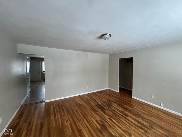 spare room with dark hardwood / wood-style flooring