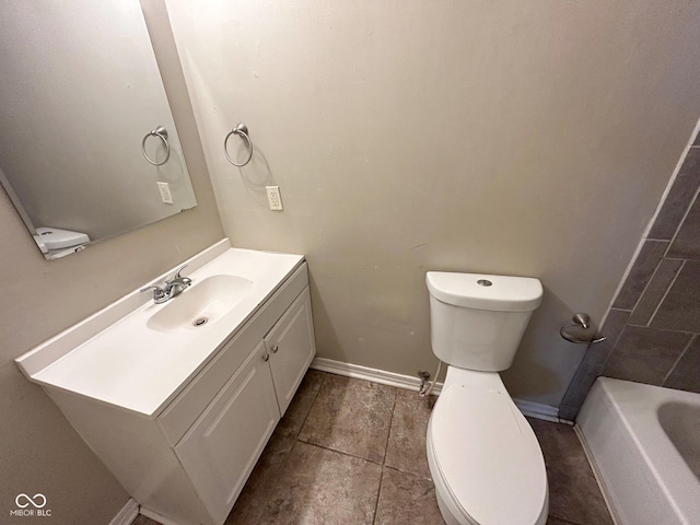 bathroom with a bath, vanity, and toilet