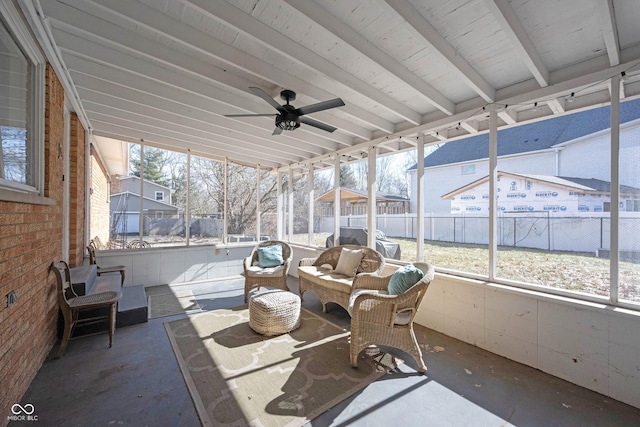 unfurnished sunroom featuring a healthy amount of sunlight and ceiling fan