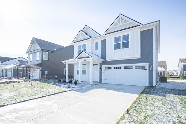 view of front of house featuring a garage, central air condition unit, and a front yard