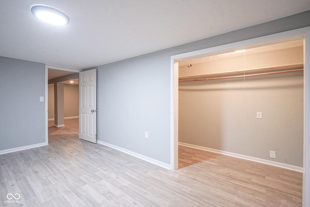 unfurnished bedroom featuring a closet and light wood-type flooring