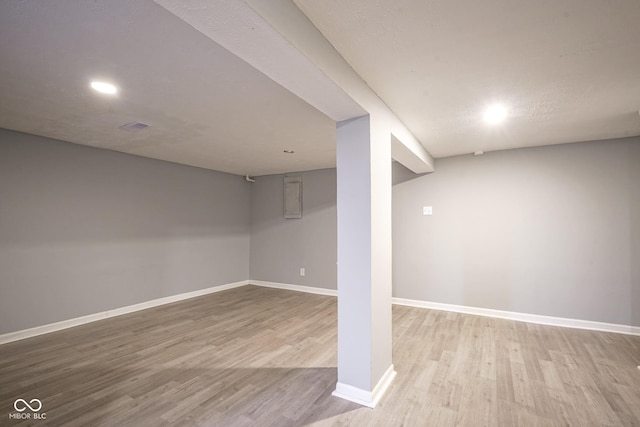 basement with light hardwood / wood-style flooring