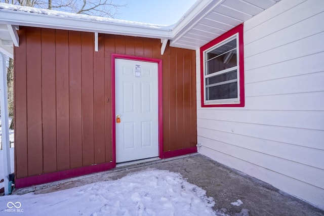 view of snow covered property entrance