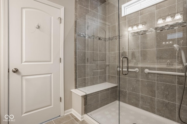 bathroom with tile patterned flooring and a shower with shower door