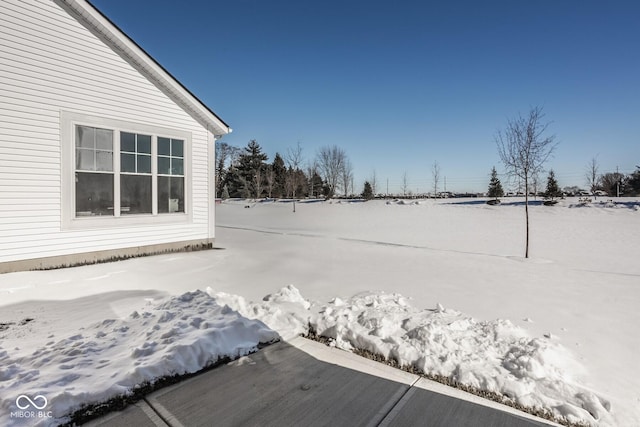 view of yard layered in snow