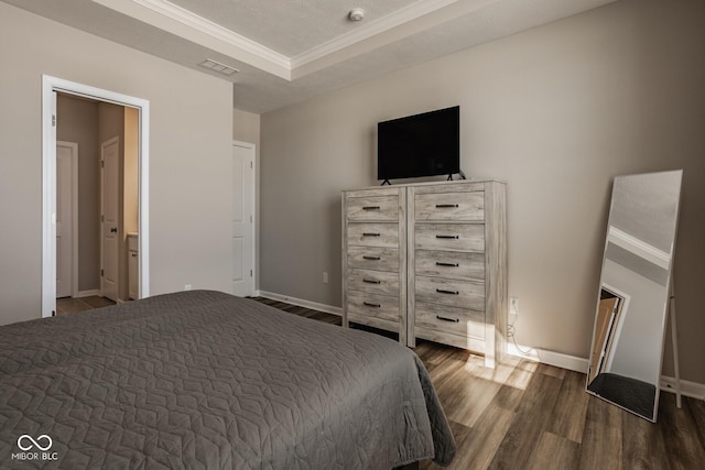 bedroom with ornamental molding and dark hardwood / wood-style floors